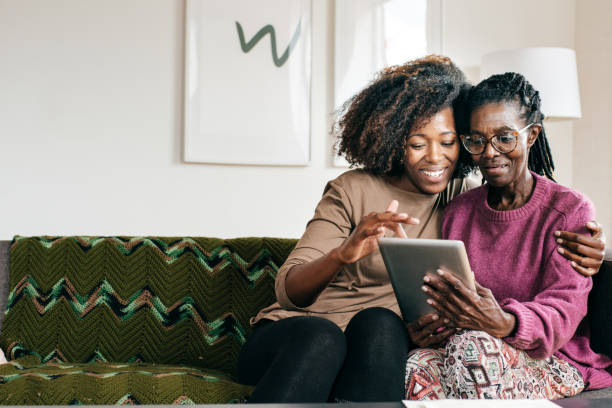 istock Smiling senior  and caregiver  with tablet 1094995150