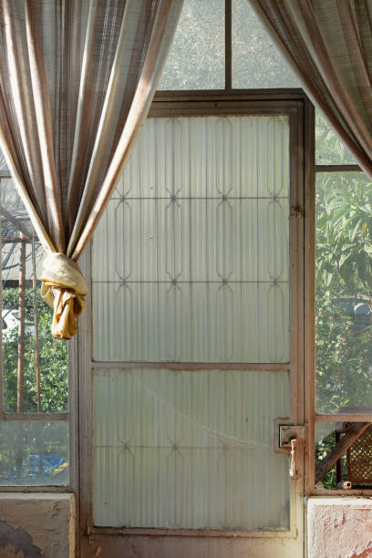 istock Glass door broken windows and old fashioned drapes 1094995340