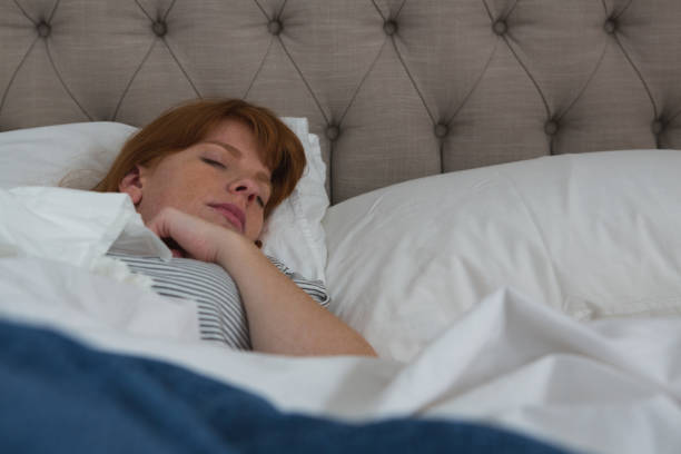 istock Woman sleeping in bedroom 1094995596