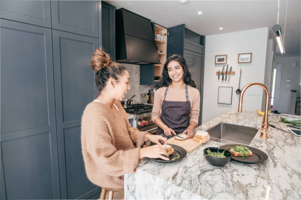 istock Two female  students working on a project at home 1094995652