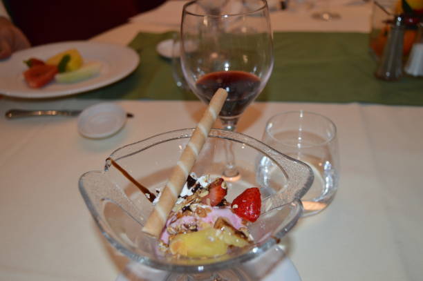istock Exquisite dessert with ice cream, decorated with strawberries, fruit and wine, dinner in the restaurant 1094995896