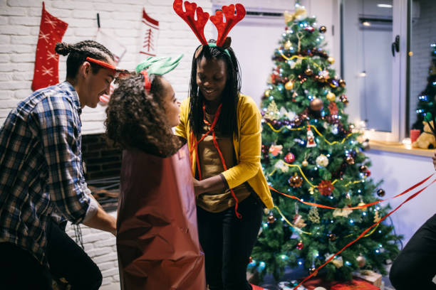 istock Friends having fun while preparing Christmas gifts 1094996436