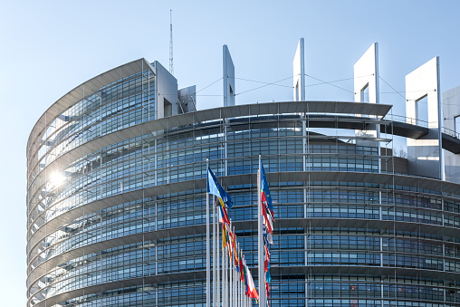 Strasbourg, France - June 6, 2018: All European Union members states flags in front of European Parliament building on a clear blue sky day before European elections 2019 photograph to illustrate political articles and news