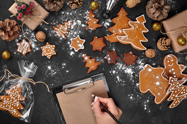 istock Christmas cookie tree made with star cookie cutter gingerbread new year pastry decorated with rope bow and form for cutting out cookies on black table. 1094999708