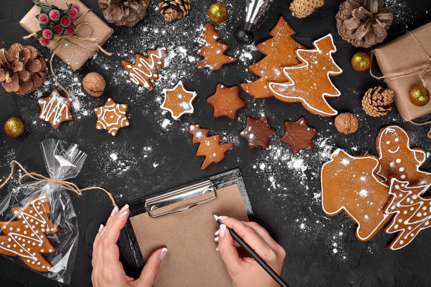 istock Christmas cookie tree made with star cookie cutter gingerbread new year pastry decorated with rope bow and form for cutting out cookies on black table. 1094999720