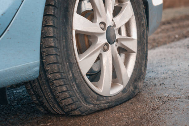 istock Flat rear tire on a car 1095000652