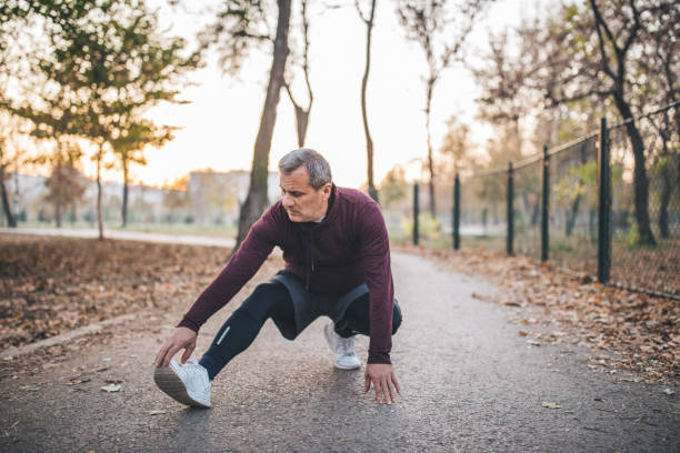 istock Active senior stretches at the park 1095016134