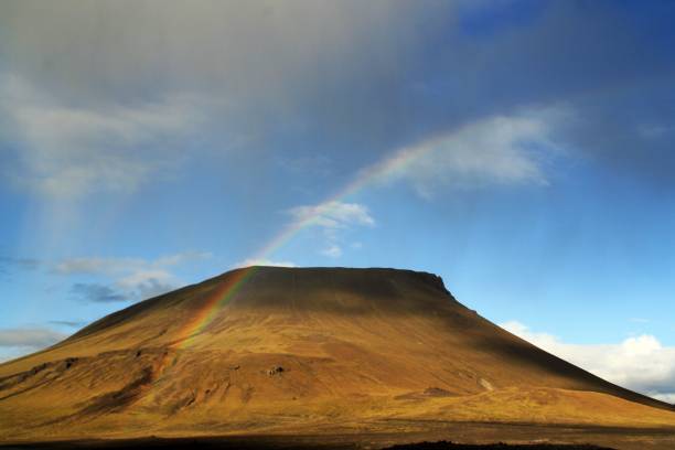 istock Rainbow over a volcanic hill, beautiful picture. 1095021394