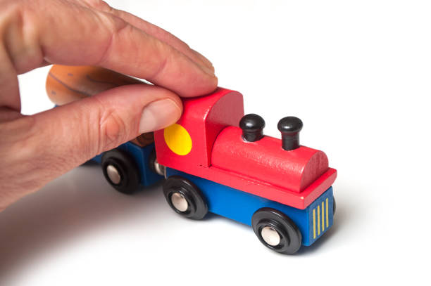 istock man playing with wooden train toy on white background 1095021692