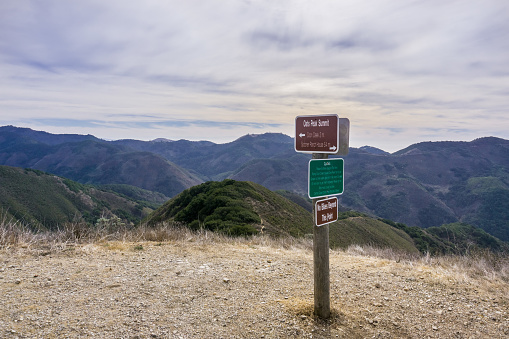 Posted signs showing distances and directions and other notices in Montana de Oro State Park placed on Oats Peak, one of the highest in the park, Los Osos, San Luis Obispo, California