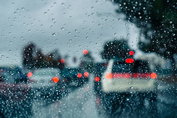 Heavy traffic during a rainy day; raindrops on the window Heavy traffic during a rainy day; raindrops on the window heavy rainfall stock pictures, royalty-free photos & images