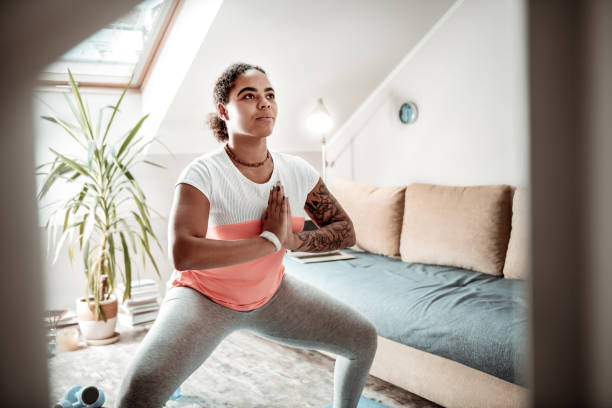 istock Dark-haired concentrated woman staying in prayerful posture 1095030076
