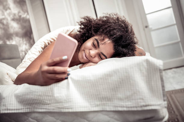 istock Curly cheerful woman being satisfied with sleep 1095030176