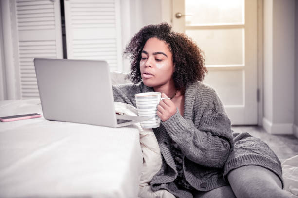 istock Curly short-haired woman spending peaceful time at home 1095030286