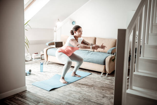 istock Joyful sportive woman spending time at home 1095030358