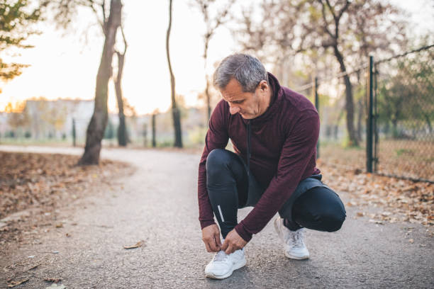 istock Senior runner tying shoelace 1095030424