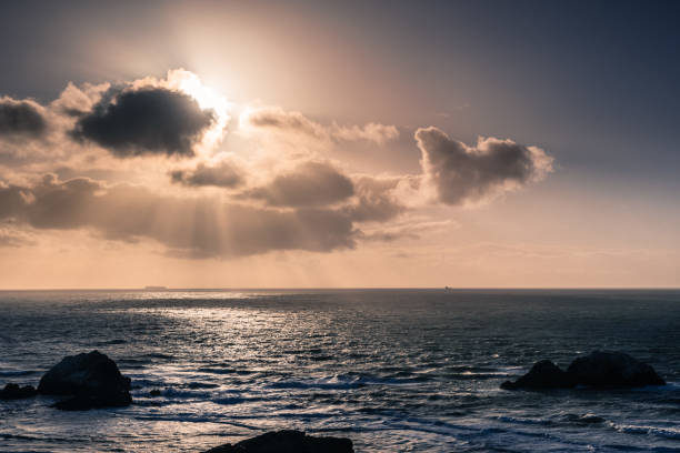 istock Sun bursting from behind clouds, Lands End, San Francisco, California 1095031770