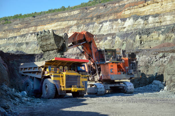 istock Large quarry dump truck. Loading the rock in the dumper. Loading coal into body work truck. Mining truck mining machinery, to transport coal from open-pit 1095033852