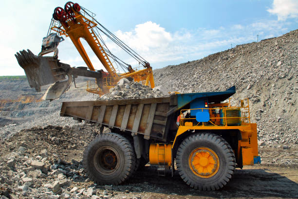 istock Large quarry dump truck. Loading the rock in the dumper. Loading coal into body work truck. Mining truck mining machinery, to transport coal from open-pit 1095033856