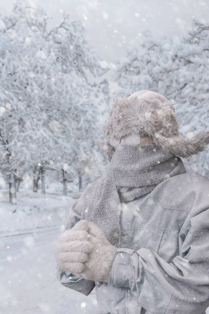 istock Frozen man clutching hands shivering from the cold temperatures outdoors in the snow 1095034192