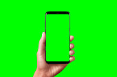 Modern phone in hand isolated. Chroma key for video mockup presentation.