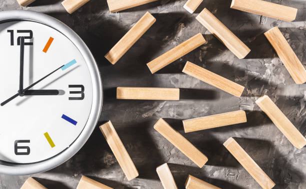 istock Clock and wooden cubes on a dark table, the top view 1095035638