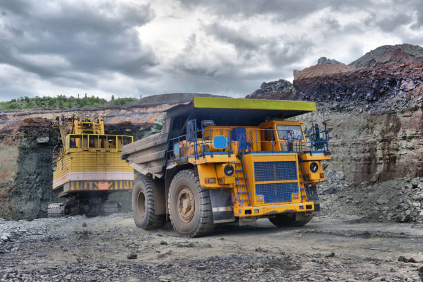 istock Large quarry dump truck. Loading the rock in the dumper. Loading coal into body work truck 1095037604