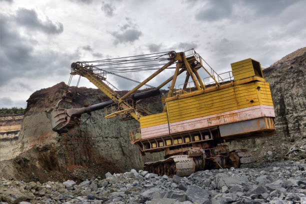 istock excavator works with granite or ore at opencast mining 1095037616