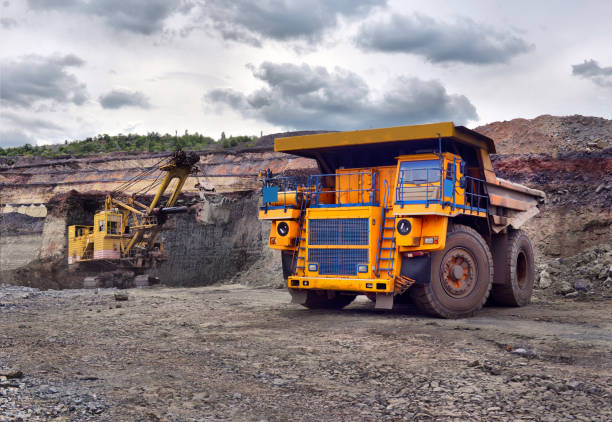 istock Large quarry dump truck. Loading the rock in the dumper. Loading coal into body work truck 1095037828