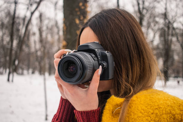 istock Woman takes photo with digital camera 1095038000