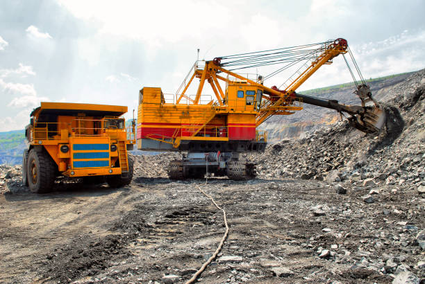 istock Large quarry dump truck. Loading the rock in the dumper. Loading coal into body work truck 1095038492
