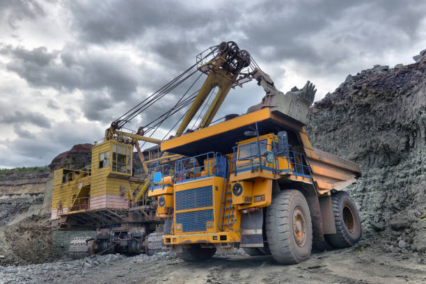 istock Large quarry dump truck. Loading the rock in the dumper. Loading coal into body work truck. Mining truck mining machinery, to transport coal from open-pit 1095039950