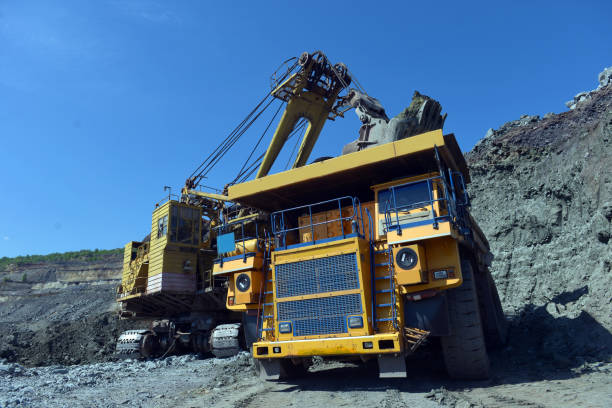 istock Large quarry dump truck. Loading the rock in the dumper. Loading coal into body work truck. Mining truck mining machinery, to transport coal from open-pit 1095040018