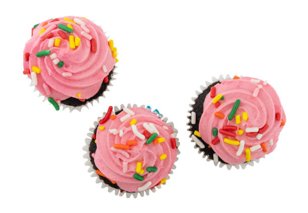 12 cupcakes in a plastic tray decorated with candy sprinkles