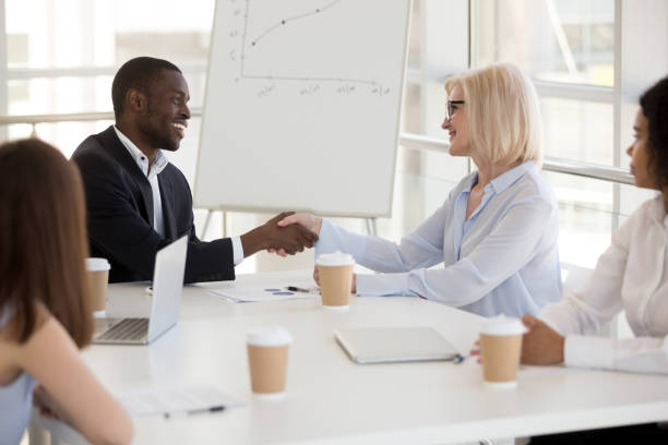 istock Diverse partners shaking hands at business meeting, respect concept 1095047032