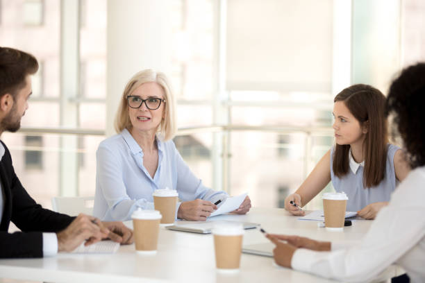 istock Serious mature executive speaking at office briefing to employees team 1095047056