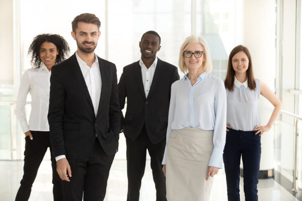 istock Workers group and leaders standing in office looking at camera 1095047176