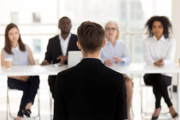 istock Rear view at job seeker during interview with hr team 1095047178