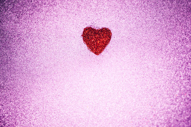 istock Red glitter heart on a pink background 1095051632