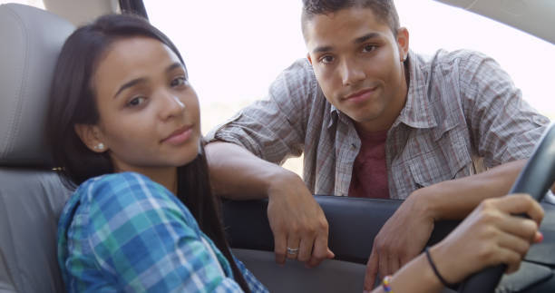 istock Happy young couple smiling in car and looking at camera 1095055508
