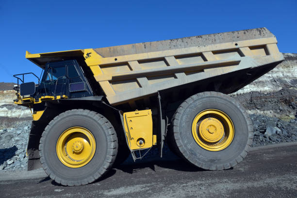 istock Large quarry dump truck. Loading the rock in the dumper. Loading coal into body work truck 1095056538