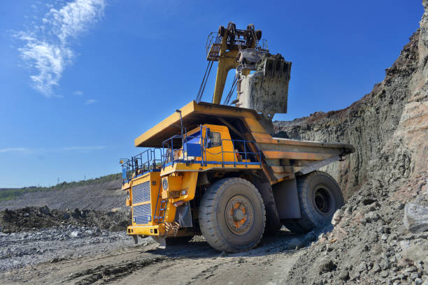 istock Large quarry dump truck. Loading the rock in the dumper. Loading coal into body work truck. Mining truck mining machinery, to transport coal from open-pit 1095057764