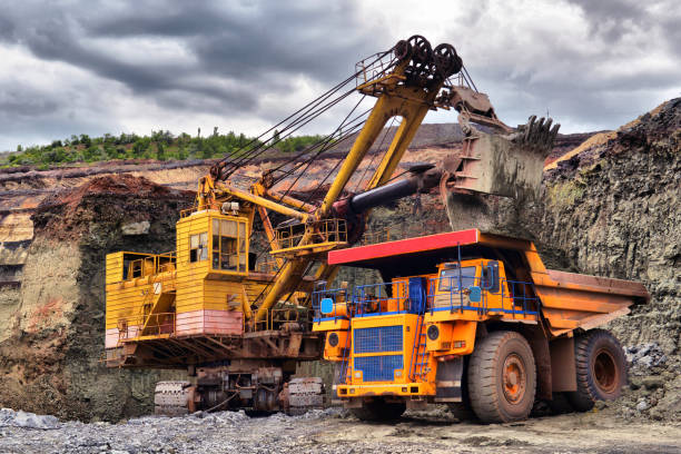 istock Large quarry dump truck. Loading the rock in the dumper. Loading coal into body work truck. Mining truck mining machinery, to transport coal from open-pit 1095057976