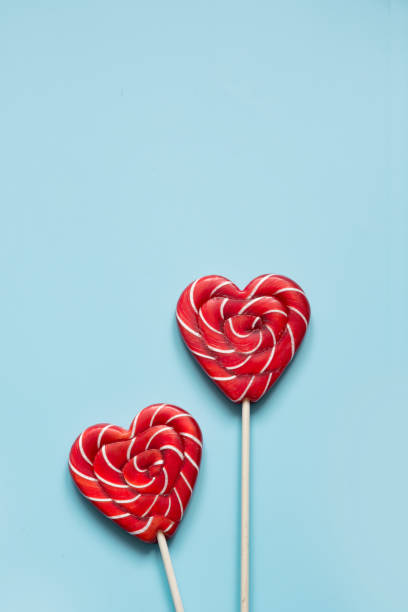 istock Valentine's card. Lollipops candy as heart on blue. Funny concept. 1095062634
