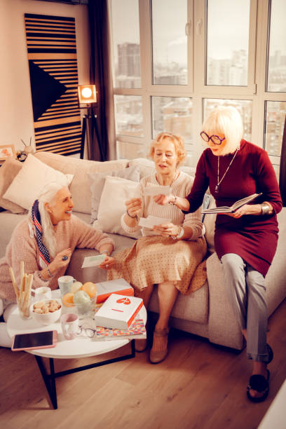 istock Pleasant elderly women looking at old photos 1095066212