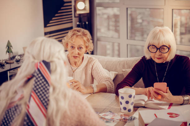 istock Nice aged woman looking at her smartphone screen 1095066246