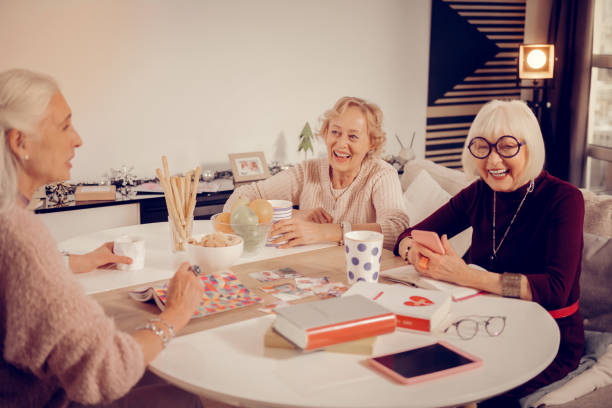 istock Positive senior women sitting around the table 1095066264