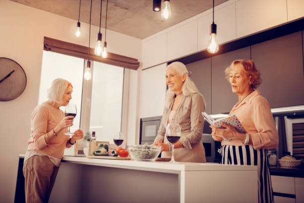 istock Positive elderly women standing together in the kitchen 1095066276
