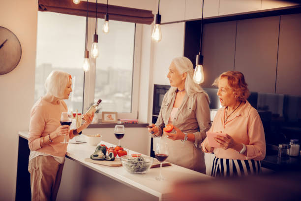 istock Nice aged women wanting to prepare dinner together 1095066284