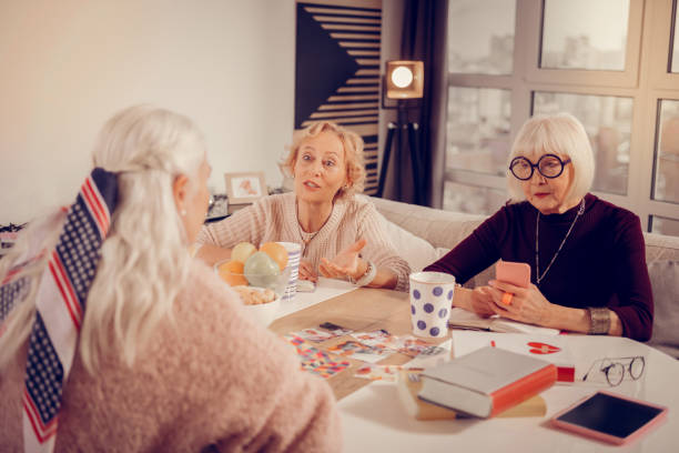 istock Pleasant grey haired woman holding her smartphone 1095066302